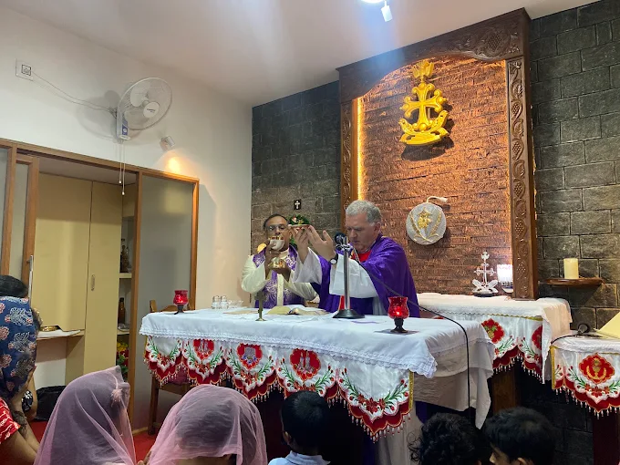 Hands raised in prayer during the celebration of the Eucharist.